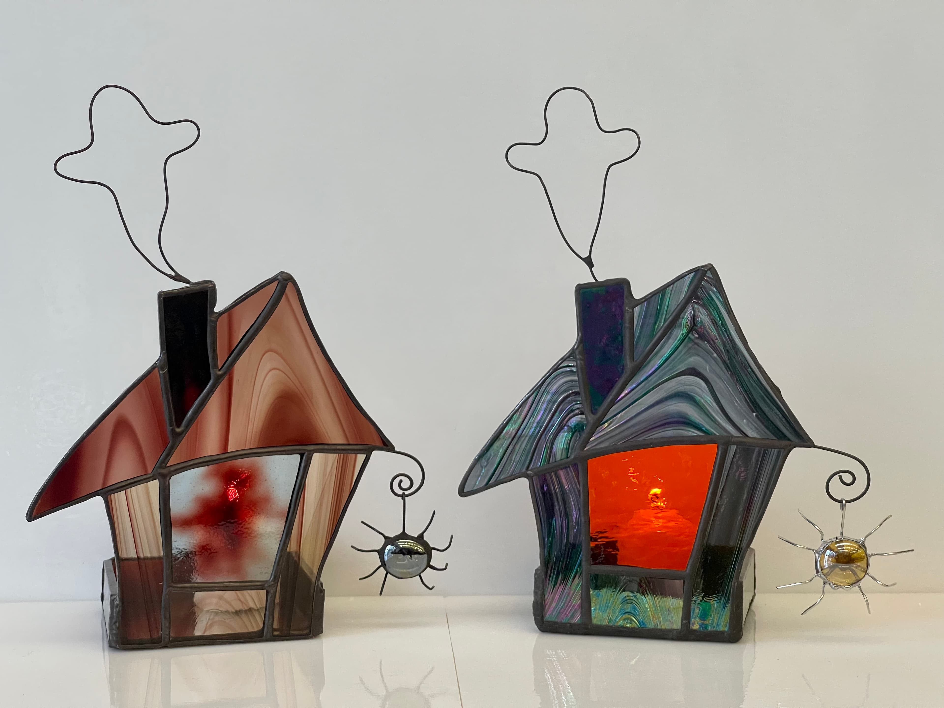 2 stained glass votive holders that look like haunted houses